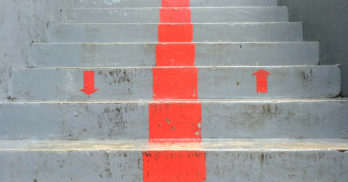 image of concrete stairs with a painted dividing line and up and down arrows.