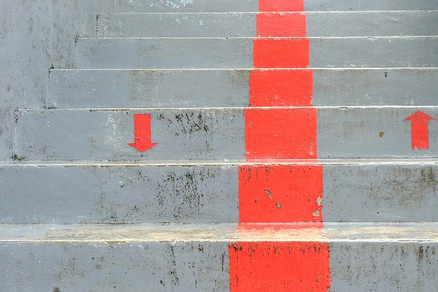 image of concrete stairs with a painted dividing line and up and down arrows.