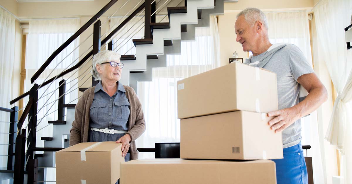 image of a man and woman moving cardboard boxes
