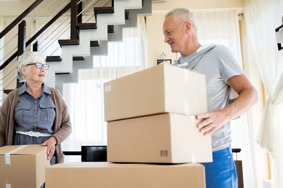 image of a man and woman moving cardboard boxes