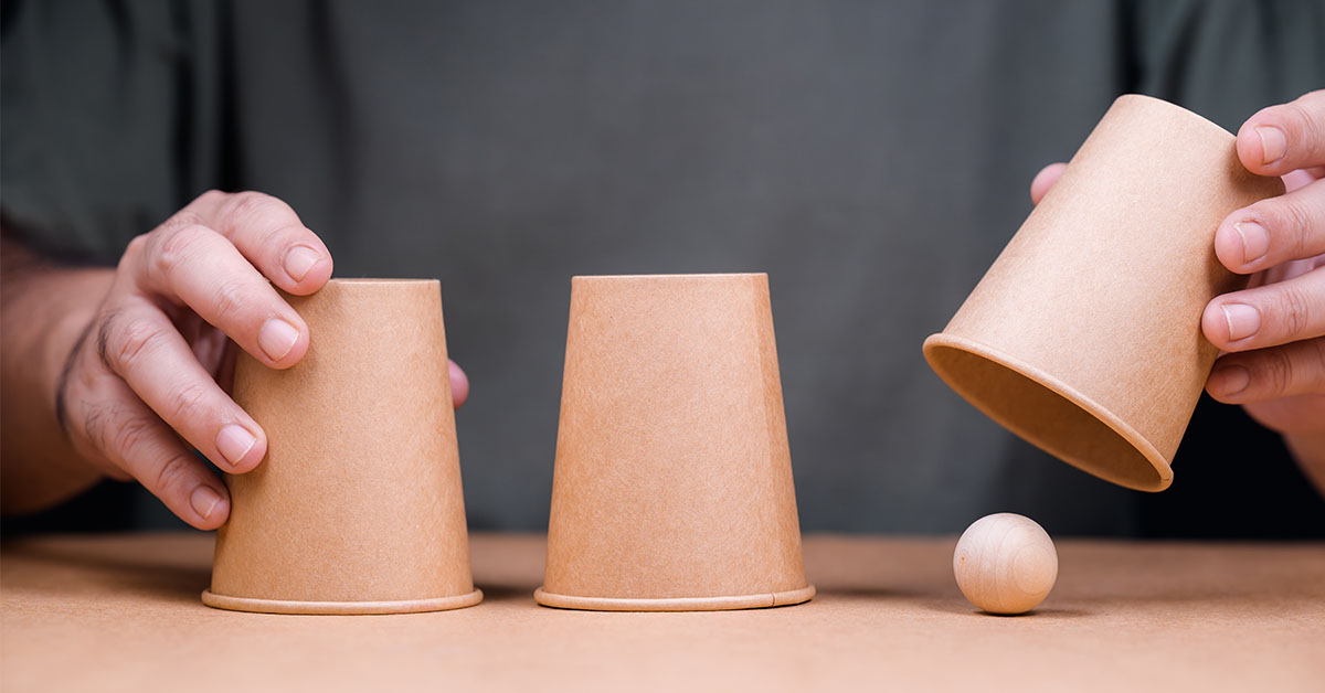 Image of a "shell game: with ball and cups