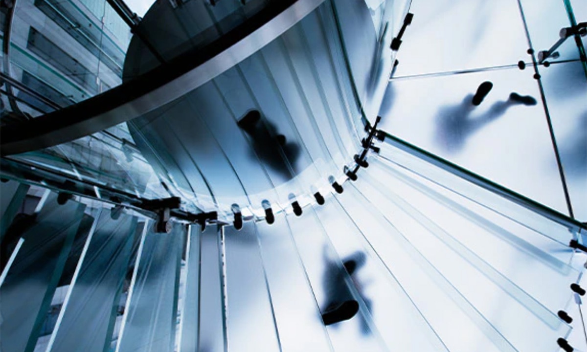 Spiral staircase with people in silhouette