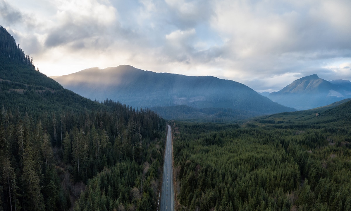 a straight road through the mountains