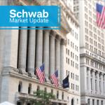 Schwab Market Update:  A view of Wall Street, including street signs, flags, and buildings.