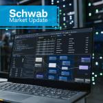 Schwab Market Update An open laptop sits on a desk in a data center, with two people and rows of servers in the background.