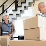 image of a man and woman moving cardboard boxes