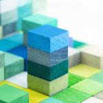 Image of stacked, multi-colored wood blocks.