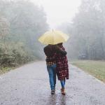 Couple walking in the rain under an umbrella