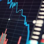 A chart showing a falling blue line, representing falling stock prices during a recession.
